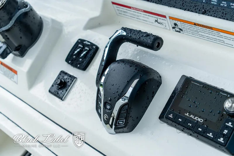 Slide: The Image of Control panel of 2025 Pathfinder Open 2400 boat with throttle and audio system. - 12