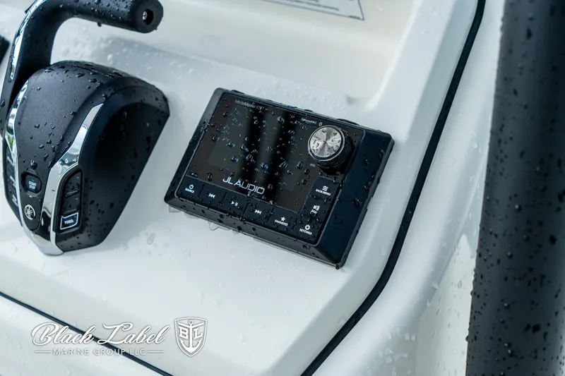 Slide: The Image of Wet dashboard of 2025 Pathfinder Open 2400 with JL Audio system and controls. - 13