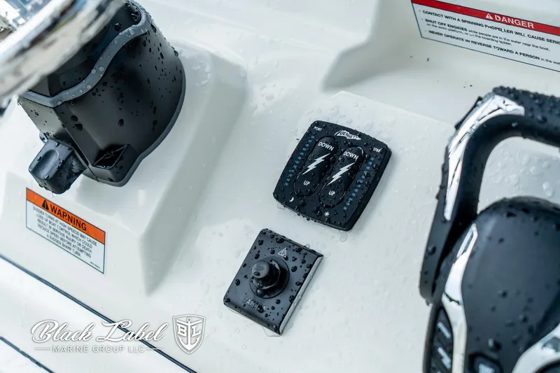 Slide: The Image of Control panel of 2025 Pathfinder Open 2400 boat, featuring switches and joystick. - 14
