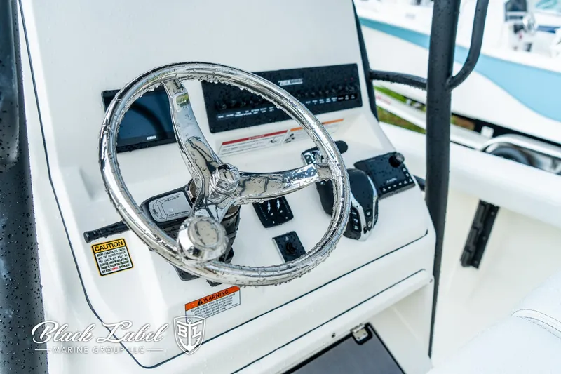 Slide: The Image of Steering console of 2025 Pathfinder Open 2400 boat, featuring modern controls and design. - 16