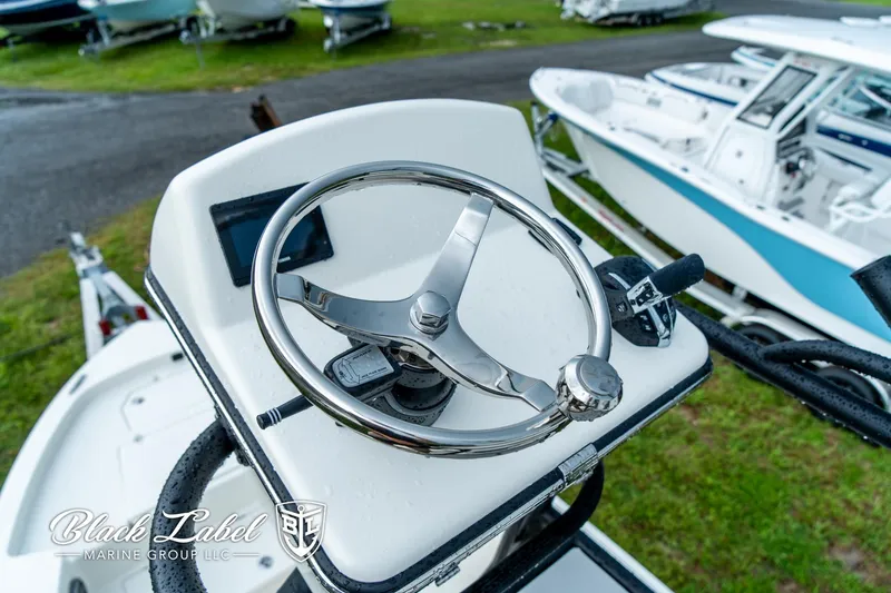 Slide: The Image of Steering wheel of 2025 Pathfinder Open 2400 boat, displayed outdoors. - 18