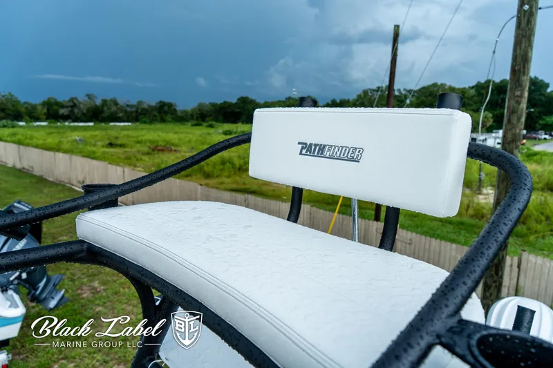 Slide: The Image of 2025 Pathfinder Open 2400 boat seat with logo, outdoors on a cloudy day. - 20