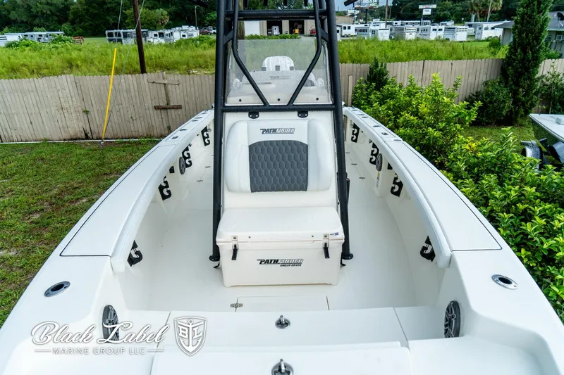 Slide: The Image of 2025 Pathfinder Open 2400 boat, white interior, center console, lush greenery background. - 3