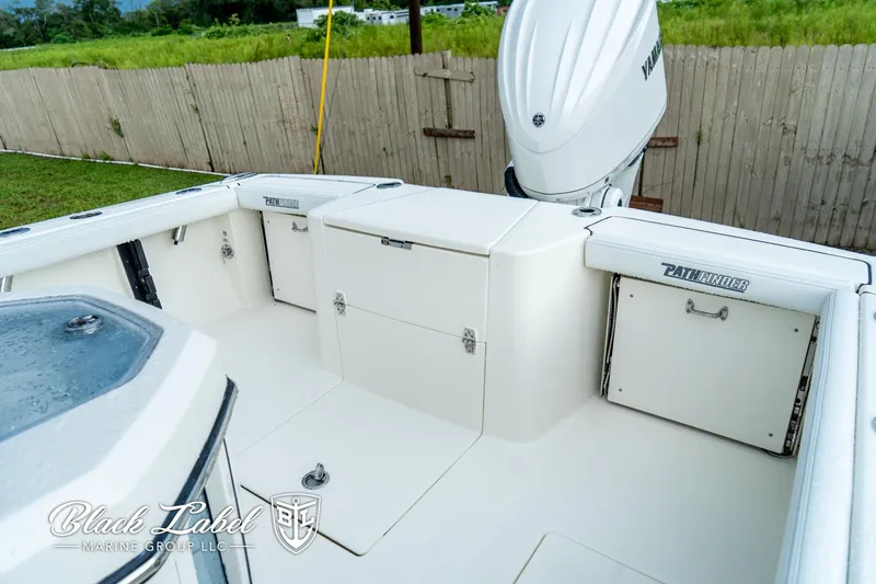 Slide: The Image of 2025 Pathfinder Open 2400 boat interior with storage compartments and motor, by Black Label Marine Group. - 6