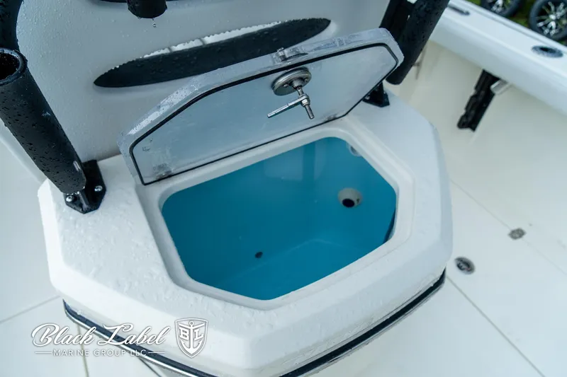 Slide: The Image of Open storage compartment on 2025 Pathfinder Open 2400 boat, featuring a blue interior. - 9
