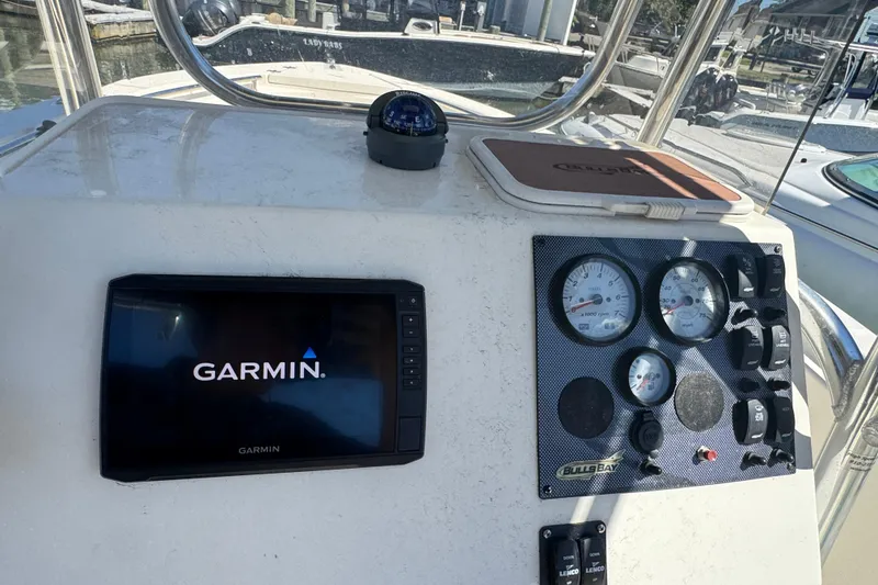 Slide: The Image of 2019 Bulls Bay 230 Center Console dashboard with Garmin display and gauges. - 11
