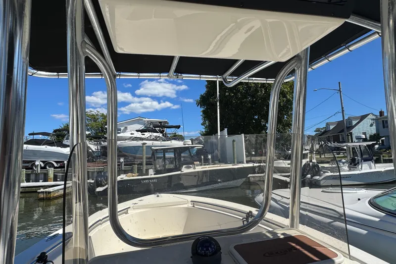 Slide: The Image of 2019 Bulls Bay 230 Center Console boat docked at marina under clear blue sky. - 12