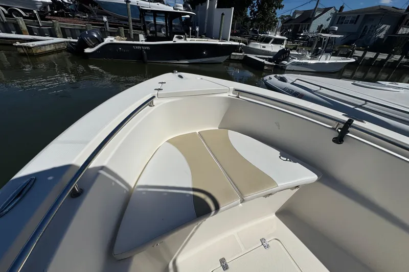 Slide: The Image of 2019 Bulls Bay 230 Center Console boat docked, featuring spacious seating and sleek design. - 20