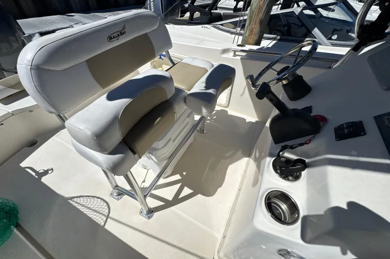 Slide: The Image of 2019 Bulls Bay 230 Center Console boat interior with steering wheel and seating. - 22