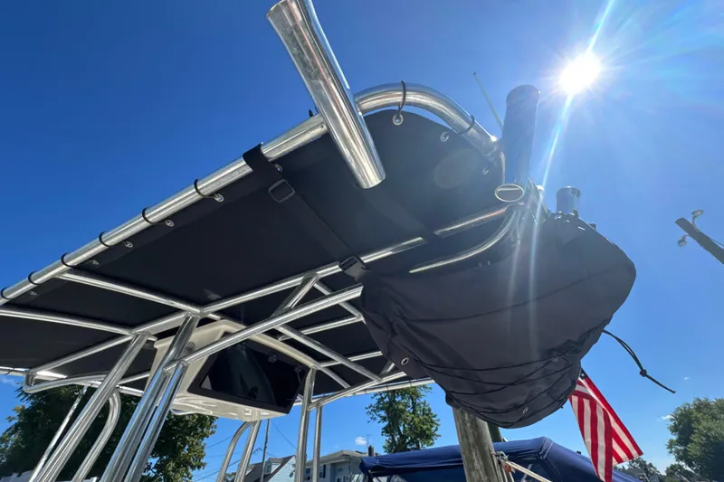 Slide: The Image of 2019 Bulls Bay 230 Center Console boat with T-top under clear blue sky. - 24