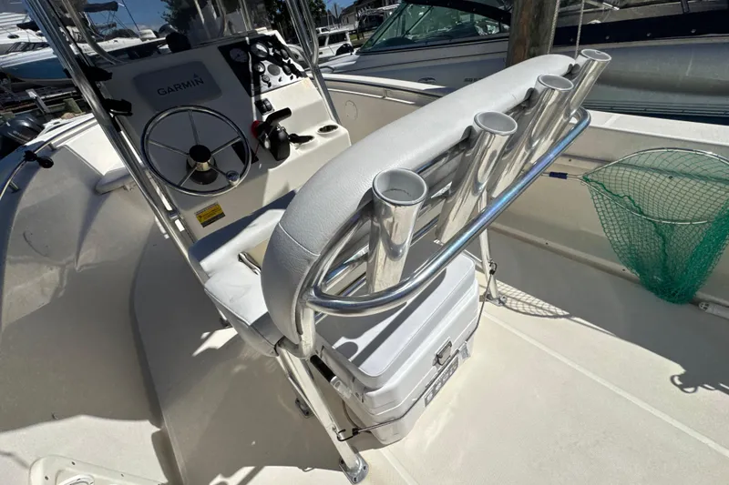 Slide: The Image of 2019 Bulls Bay 230 Center Console boat interior with steering wheel and rod holders. - 25
