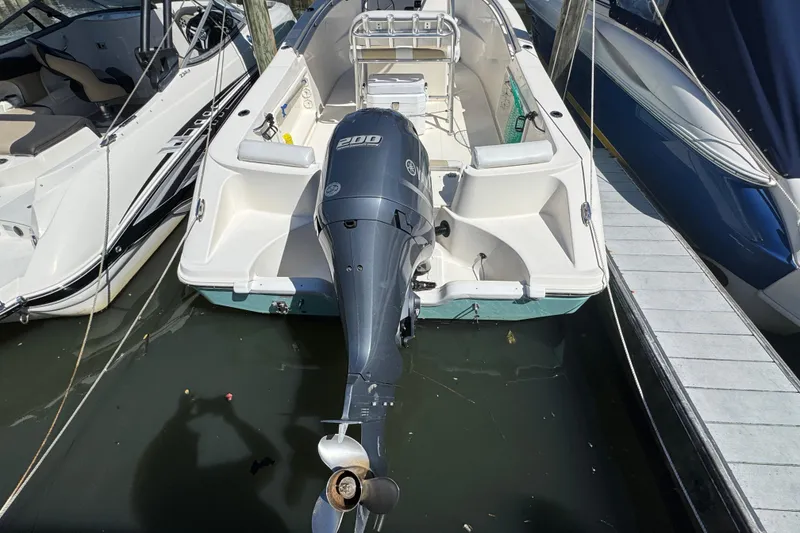 Slide: The Image of 2019 Bulls Bay 230 Center Console boat docked with powerful outboard motor. - 3