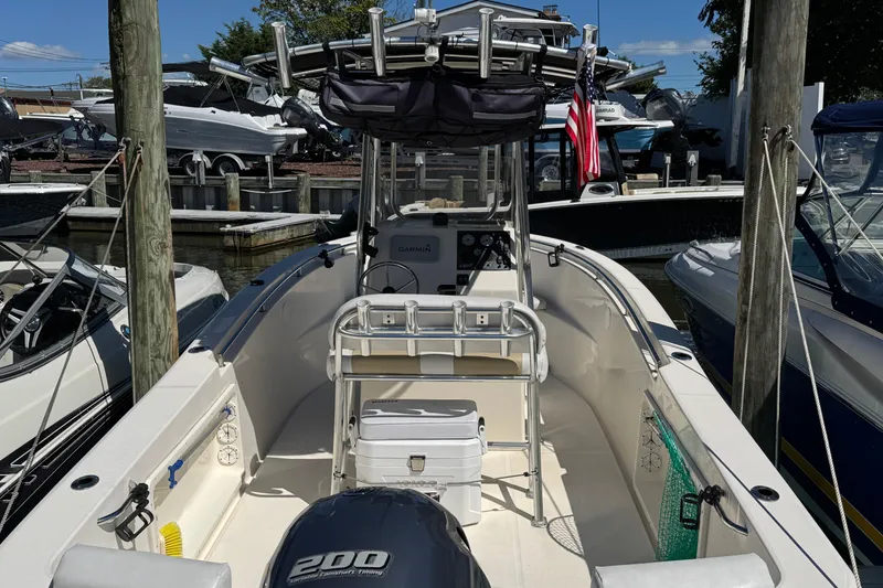 Slide: The Image of 2019 Bulls Bay 230 Center Console boat docked, featuring a 200 horsepower engine. - 4
