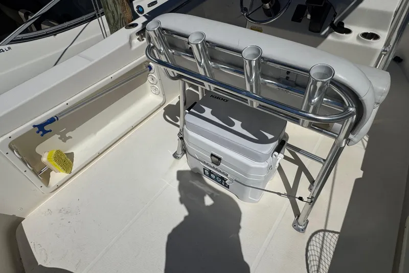 Slide: The Image of 2019 Bulls Bay 230 Center Console boat interior with rod holders and cooler. - 6
