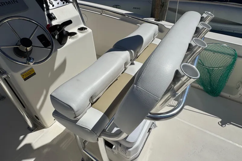 Slide: The Image of 2019 Bulls Bay 230 Center Console boat interior with steering wheel and rod holders. - 8