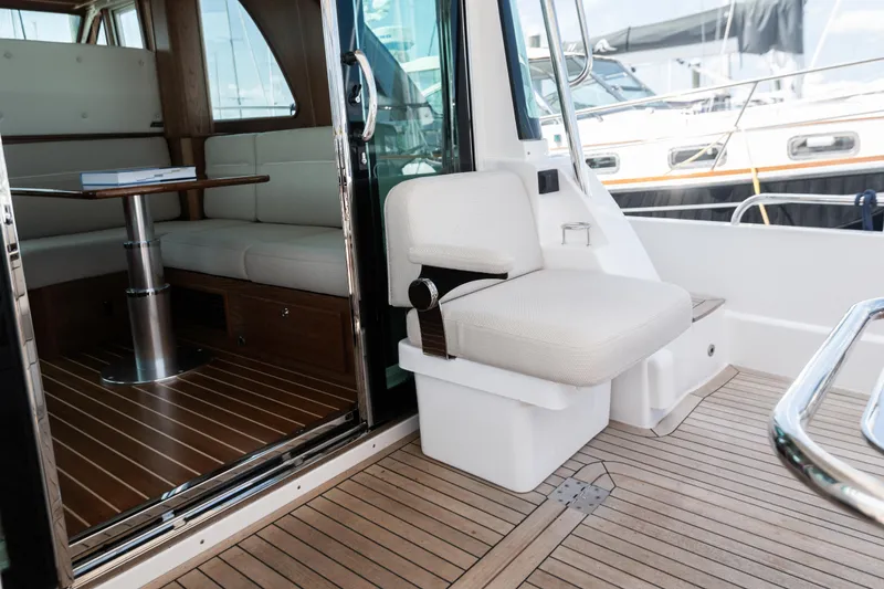 Slide: The Image of 2025 Sabre 43 Salon Express interior with seating and wooden flooring. - 12
