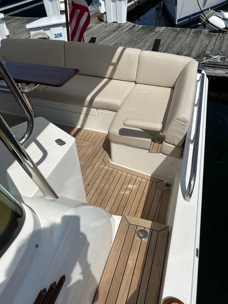 Slide: The Image of 2025 Sabre 43 Salon Express yacht with teak deck and cushioned seating. - 16