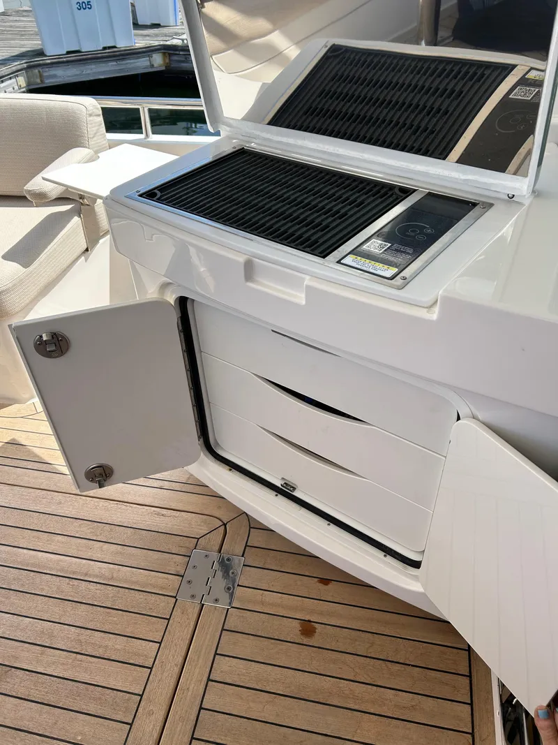 Slide: The Image of Outdoor kitchen on 2025 Sabre 43 Salon Express yacht with grill and storage. - 19
