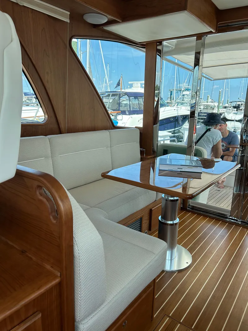 Slide: The Image of 2025 Sabre 43 Salon Express interior with elegant seating and wooden finishes. - 23