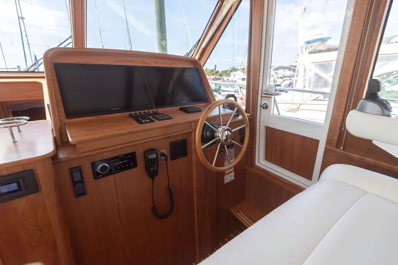 Slide: The Image of Interior helm of 2025 Sabre 43 Salon Express yacht with wooden finish and modern controls. - 30