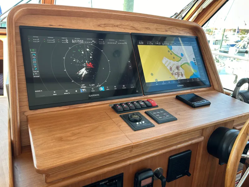 Slide: The Image of 2025 Sabre 43 Salon Express helm with dual navigation screens and controls. - 32