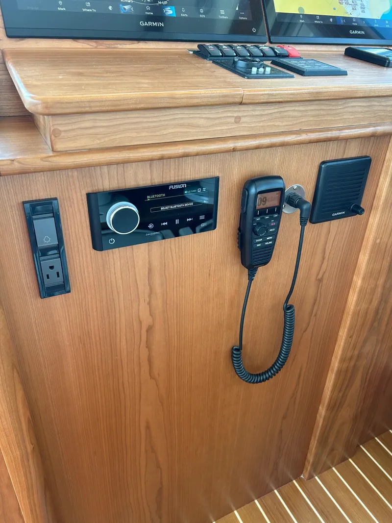 Slide: The Image of 2025 Sabre 43 Salon Express dashboard with radio and communication equipment. - 33