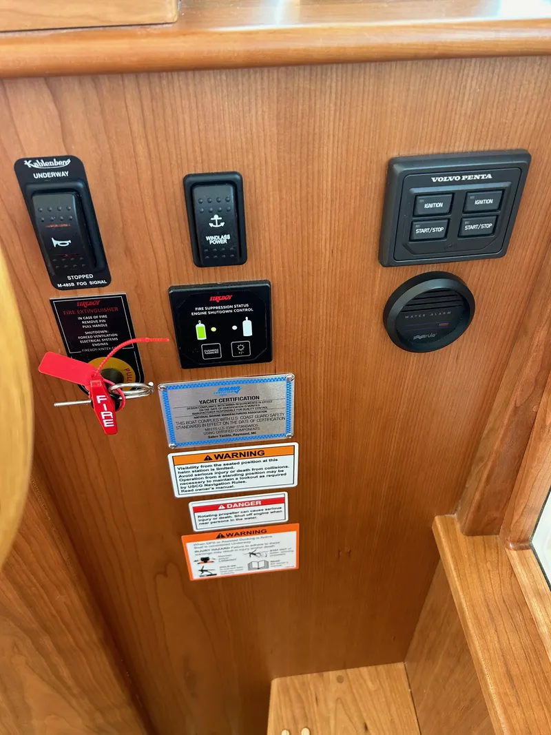 Slide: The Image of Control panel of 2025 Sabre 43 Salon Express with various switches and warning labels. - 34