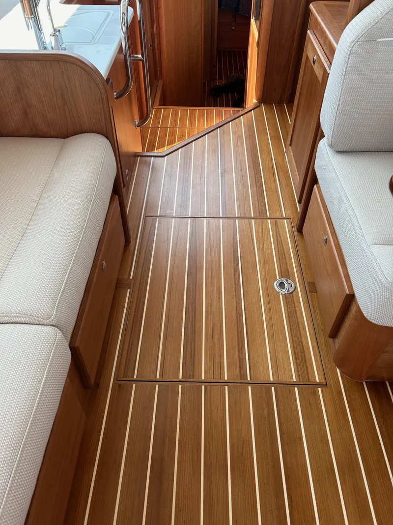 Slide: The Image of Interior of 2025 Sabre 43 Salon Express with wooden flooring and beige seating. - 36