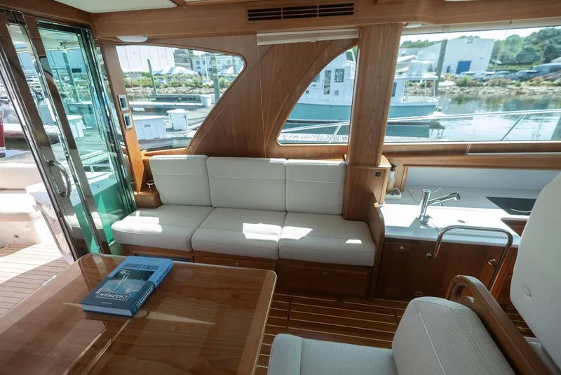 Slide: The Image of Interior of 2025 Sabre 43 Salon Express yacht with elegant seating and wooden finishes. - 41