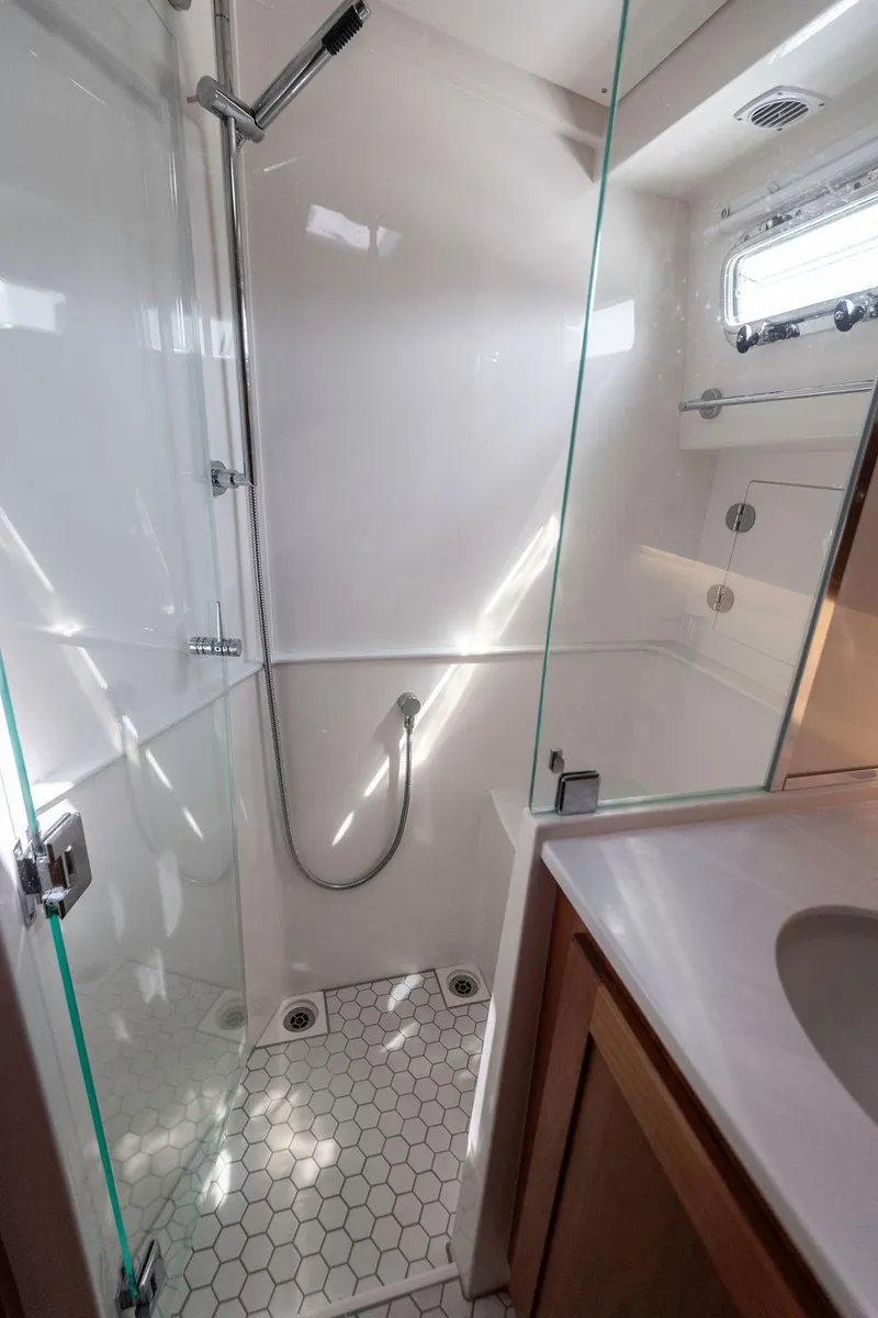 Slide: The Image of Modern bathroom in 2025 Sabre 43 Salon Express yacht with glass shower enclosure. - 45