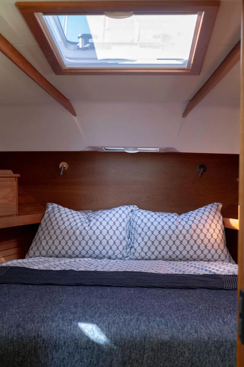 Slide: The Image of 2025 Sabre 43 Salon Express cabin with skylight and cozy bedding. - 49