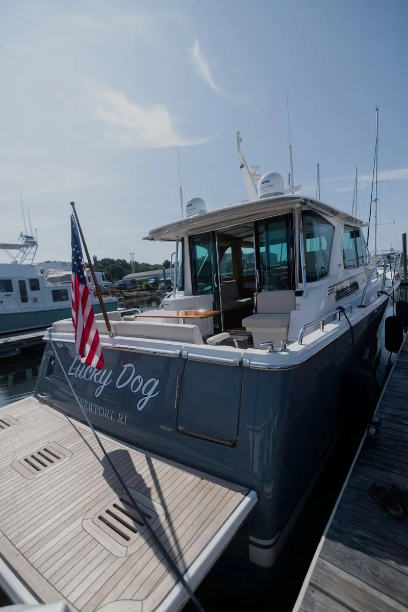 Slide: The Image of 2025 Sabre 43 Salon Express yacht docked, featuring sleek design and American flag. - 9