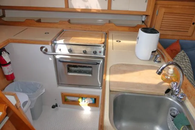 Slide: The Image of Compact kitchen in 1995 Catalina 36 Mk II sailboat with stove, sink, and storage. - 10