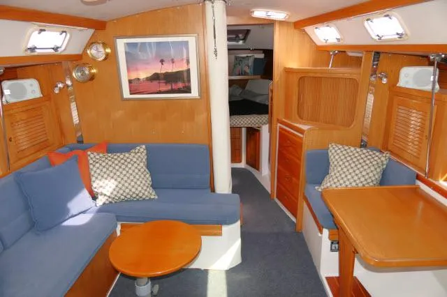 Slide: The Image of Interior of 1995 Catalina 36 Mk II sailboat with cozy seating and wooden finishes. - 2