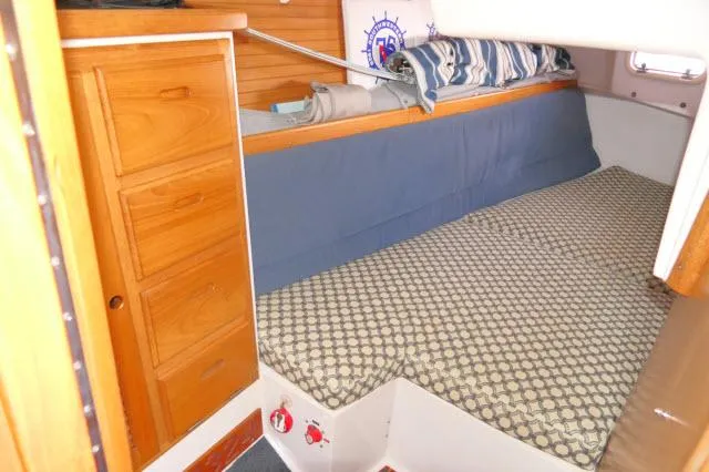 Slide: The Image of Cozy cabin interior of 1995 Catalina 36 Mk II sailboat with wooden storage and patterned bedding. - 21