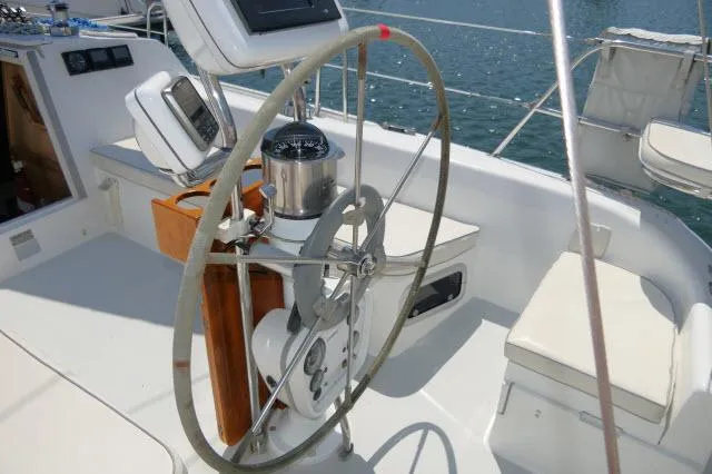 Slide: The Image of Steering wheel of a 1995 Catalina 36 Mk II sailboat, featuring navigation instruments. - 25