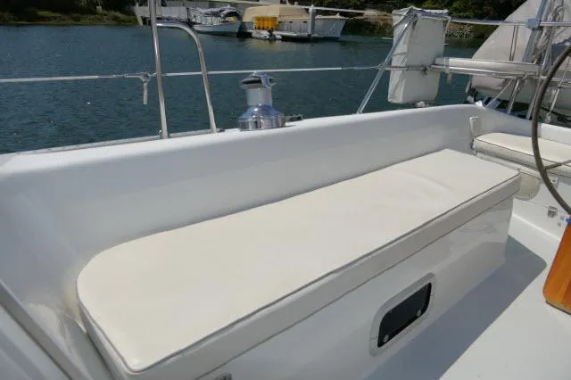 Slide: The Image of Catalina 36 Mk II 1995 sailboat cockpit seating with cushion, docked by the water. - 32