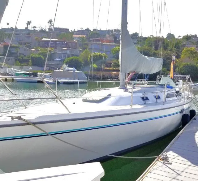 Slide: The Image of 1995 Catalina 36 Mk II sailboat docked in a serene marina setting. - 34