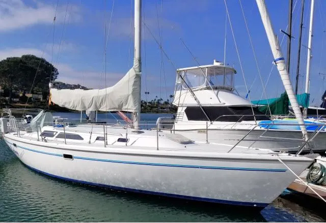 Slide: The Image of 1995 Catalina 36 Mk II sailboat docked in a marina, clear sky background. - 38