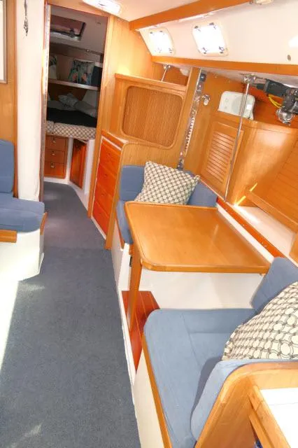 Slide: The Image of Interior of 1995 Catalina 36 Mk II sailboat with wooden furnishings and blue seating. - 4