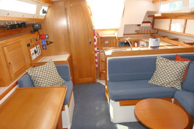 Slide: The Image of Interior of 1995 Catalina 36 Mk II sailboat with cozy seating and wooden finishes. - 6
