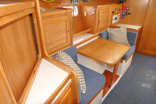 Slide: The Image of 1995 Catalina 36 Mk II interior with wooden cabinetry and blue cushioned seating. - 8