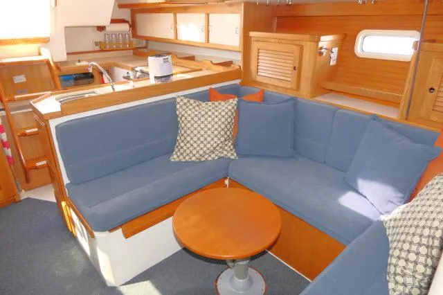 Slide: The Image of Interior of 1995 Catalina 36 Mk II sailboat with blue seating and wooden accents. - 9