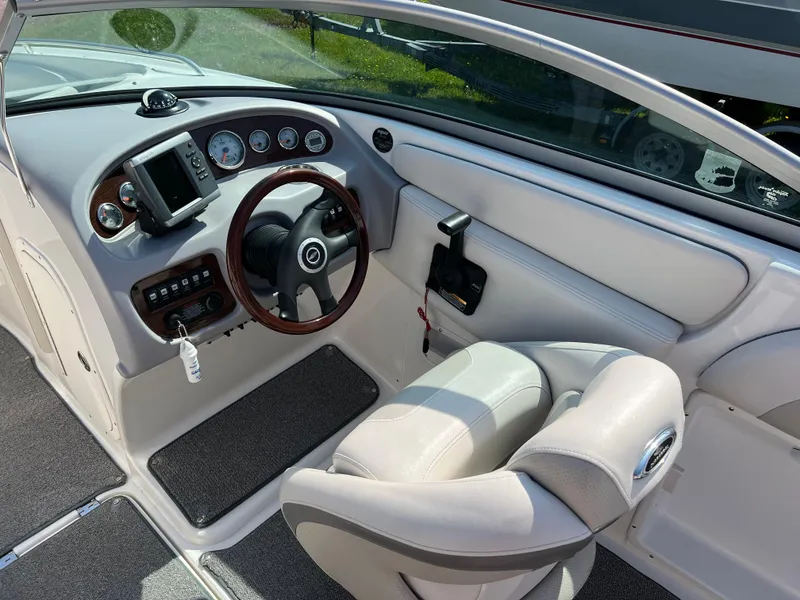 Slide: The Image of 2007 Chaparral 220 SSi boat interior with steering wheel and dashboard controls. - 11