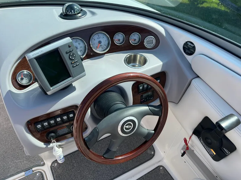 Slide: The Image of 2007 Chaparral 220 SSi boat dashboard with steering wheel, gauges, and controls. - 12