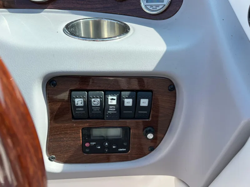 Slide: The Image of Control panel of a 2007 Chaparral 220 SSi boat with switches and cup holder. - 15