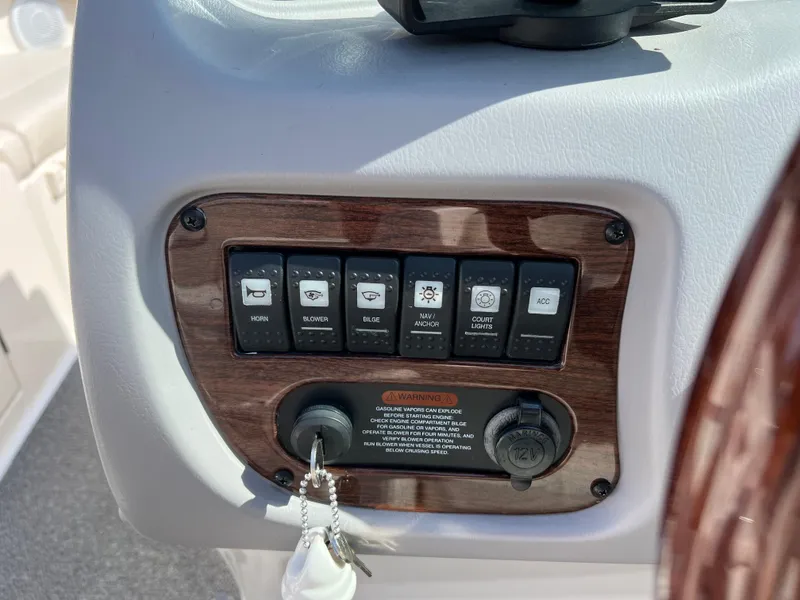 Slide: The Image of Control panel of a 2007 Chaparral 220 SSi boat with switches and key ignition. - 16