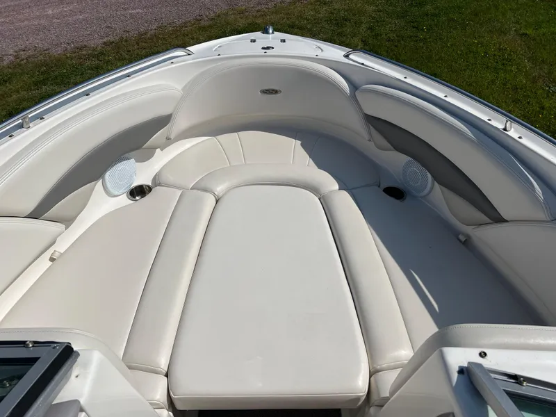 Slide: The Image of 2007 Chaparral 220 SSi boat interior with white leather seating and cup holders. - 19