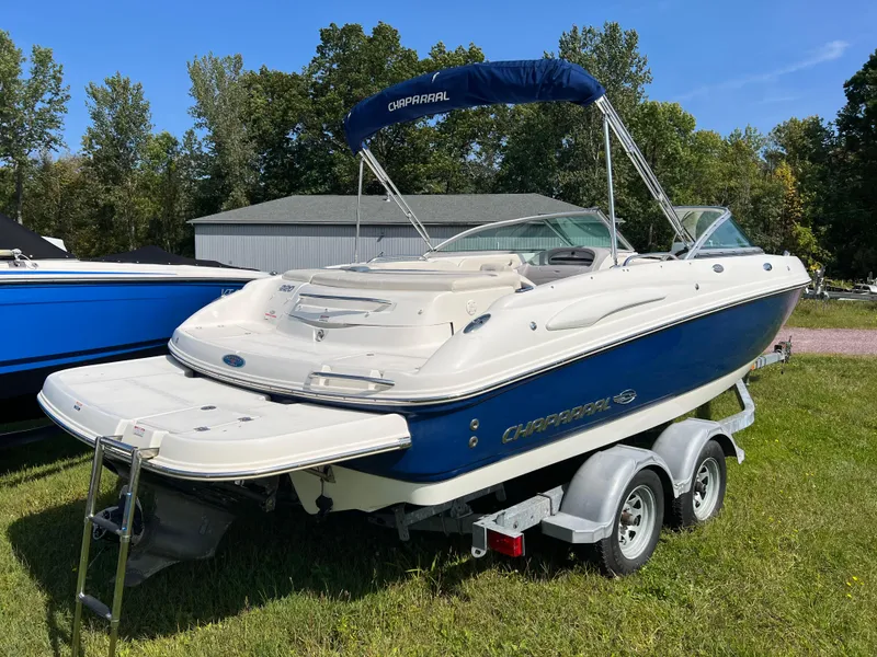 Slide: The Image of 2007 Chaparral 220 SSi boat on trailer, blue and white, parked on grass. - 2