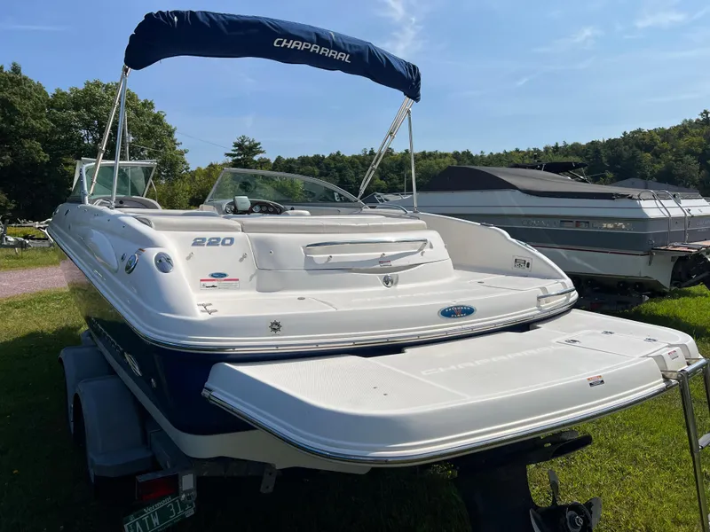 Slide: The Image of 2007 Chaparral 220 SSi boat with canopy on trailer, parked outdoors. - 3